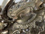 a close up of a silver purse on a table