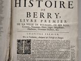 an old book with a black and white image of a man ' s face on it