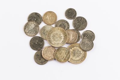 a pile of coins on a white surface
