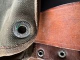 a close up of a piece of leather with rivets on it