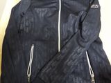 a black jacket sitting on top of a wooden table