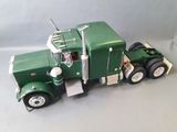 a toy truck that is green and white on the table