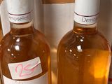 several bottles of wine are lined up on a counter