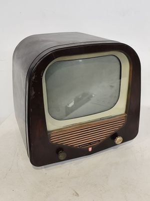 an old fashioned television sitting on a white surface