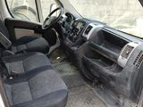 the interior of a van with the door open and the driver ' s seat down