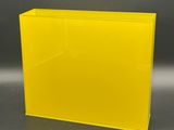 a yellow acrylic display case with a black background