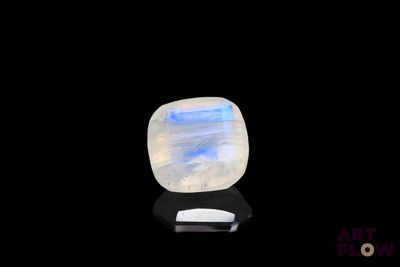 a white and blue stone on a black surface