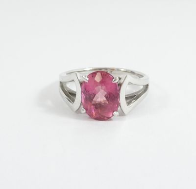 a close up of a pink tourmaline ring on a white background
