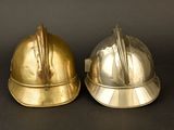 two helmets that are sitting next to each other on a table