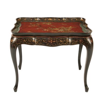 une petite table avec un plateau rouge et des pieds noirs