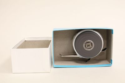a small box with a tape in it and a small box with a tape inside of it