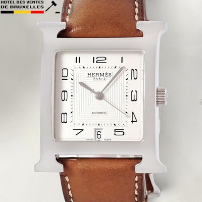 an image of a close up of a watch on a white surface