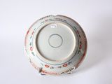a white bowl with a red and blue design on it