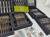 a lot of silverware in a box on a table
