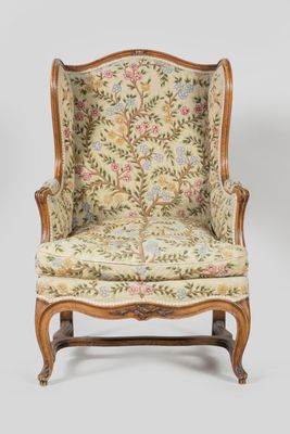 a chair with a floral upholstered back and a floral upholstered back