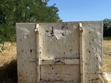 an old refrigerator sitting in the middle of a field