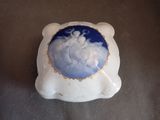 a white and blue bowl with a picture of a man on it