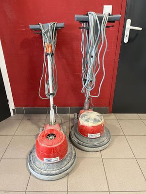 two vacuums that are sitting on the floor next to each other