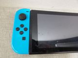 a blue and black nintendo wii game controller sitting on a table