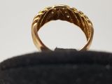 an image of a gold ring on a black surface