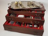 a wooden box with silverware in it on a table