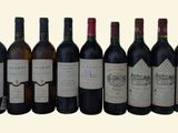 six bottles of wine are lined up in a row on a table