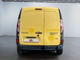 the back of a yellow van is parked in a garage