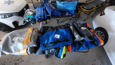 de nombreux sacs posés par terre à côté d'une voiture
