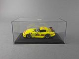 a close up of a yellow car in a clear display case