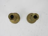 a pair of brass candlesticks on a white surface