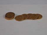 a pile of coins sitting on a table next to a pile of coins