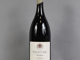 a bottle of red wine sitting on top of a table