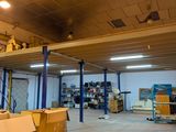 a large room with a ladder and boxes on the floor