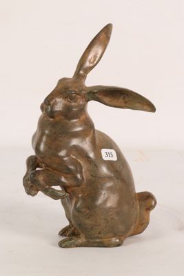 bronze sculpture of a rabbit sitting on its hind legs with a tag on it ' s ear