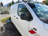 a white van that is parked next to a fence