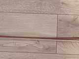a violin on the floor with a wooden stick on it