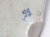 a close up of a white plate with a blue design on it