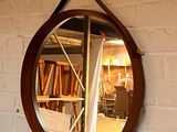 un miroir accroché à un mur de briques dans une pièce