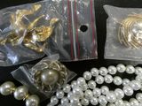 pearls and other jewelry on a black table