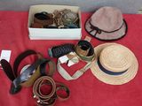 a red table with a hat, hat, belt, and other items on it