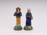 two figurines of a man and a woman standing next to each other
