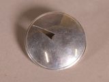 a silver button with a hole in the middle of it