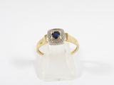 a yellow gold ring with a blue sapphire and diamonds