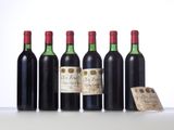 four bottles of wine sit next to each other on a table