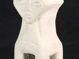 a white ceramic sculpture of a woman ' s face on a black background