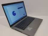 a laptop computer sitting on a table with a blue screen