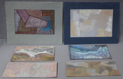 several pieces of art are displayed on a table next to each other