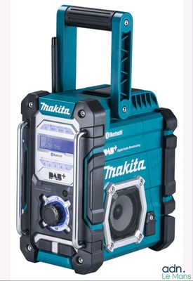 a close up of a radio that is on a white surface