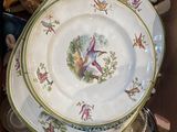 a box full of plates and bowls with birds painted on them