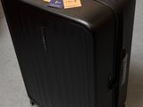 a piece of luggage sitting on the ground next to a car